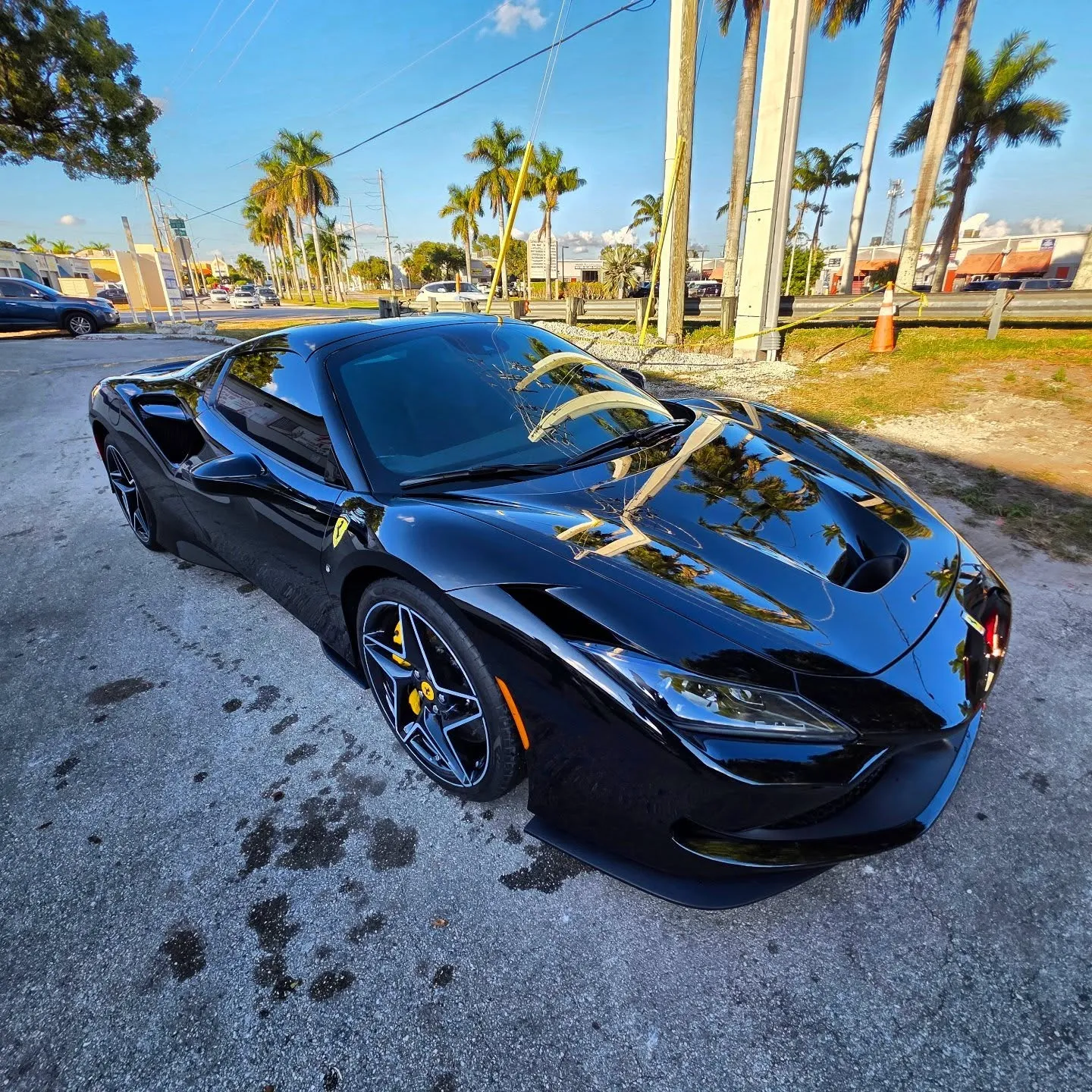 Freshly detailed black Ferrari outside Marlin Motors auto body shop in Cutler Bay, FL